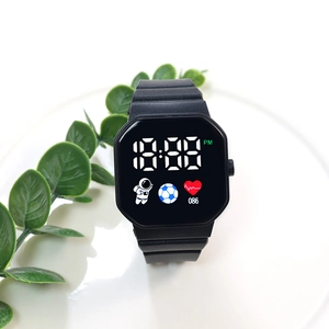 Close-up of black square LED digital watch with astronaut icon on a white plate