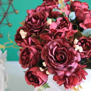 Detailed macro of dark red faux silk rose and hydrangea bouquet for home decor