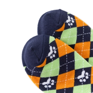 Detailed close-up of knitted cotton socks with blue and orange argyle and paw print patterns