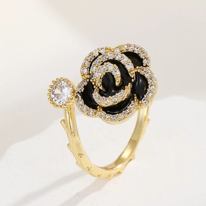 Close-up of black enamel rose ring with sparkling zircons and thorn textured band