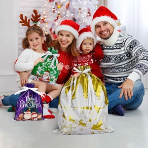 Christmas drawstring gift bags with Santa motifs shown in a cozy family holiday scene