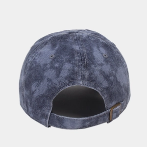 Detail of adjustable metal buckle and vintage washed denim texture on a baseball cap