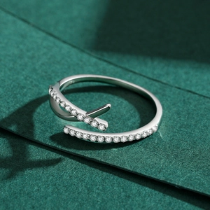 Minimalist s925 silver open ring with pavé-set cubic zirconia on textured background