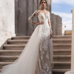 Elegant white lace wedding dress with long sleeves, deep V-neck and long tulle train