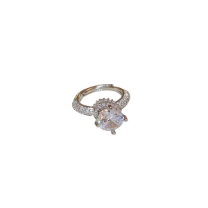 Luxury silver-toned ring with round clear gemstone and pavé-set diamond-studded band