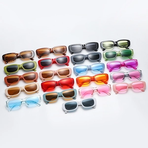 Multiple colorful candy-colored retro cat-eye sunglasses arranged neatly on white surface