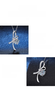 Detailed view of 1 carat moissanite pendant with elegant silver bow knot design