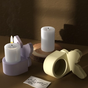 Detailed texture of matte resin rabbit candle holder with butterfly embellishments