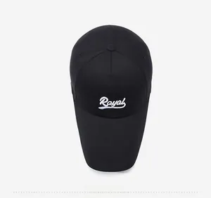 Top view of a black baseball cap with white Royal embroidery on a grey background