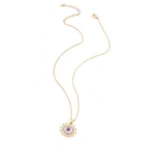 Macro shot of evil eye necklace with purple zircon stone and gold chain details