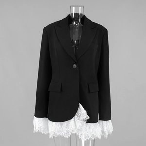 Detailed view of black blazer with white eyelash lace trim and metal waist buckle accents
