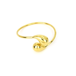 Detailed view of an 18K gold teardrop open bangle with polished asymmetric design