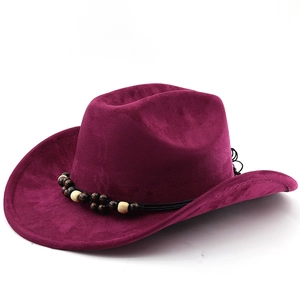 Detail of burgundy suede cowboy hat with wide brim and decorative wooden beads