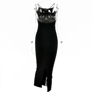 Detail view of a black slim-fit backless dress with a high slit on a clear mannequin