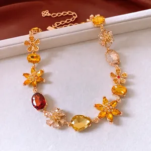 Detail of vintage flower pendant necklace with amber crystals and adjustable gold chain