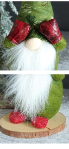 Detailed close-up of a Christmas gnome wearing a green felt hat and red gloves