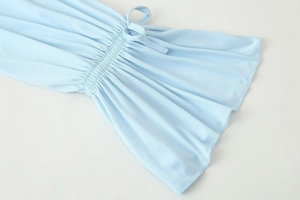Detail of light blue flared cuff with delicate smocking and a matching tie-up string