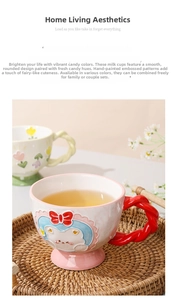 Detail view of pink ceramic mug with red twisted handle and hand-painted relief art