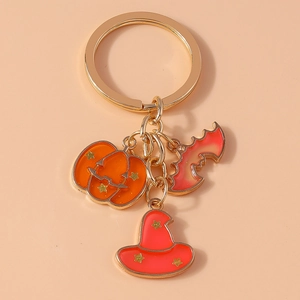 Detail of Halloween keychain with orange pumpkin, red bat, and wizard hat pendants