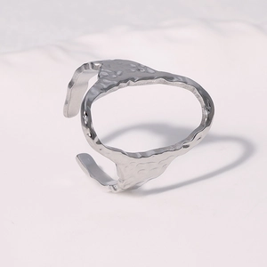 Macro detail of silver oval open ring featuring a unique hammered metal texture