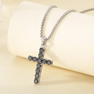 Macro view of silver cross pendant with black gemstones and durable box chain