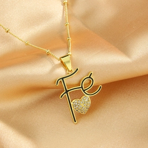 18k gold plated Fé letter pendant necklace with a small zircon heart on silk background