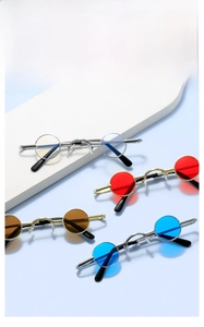 Macro shot of multiple vintage mini round metal sunglasses in various vibrant colors