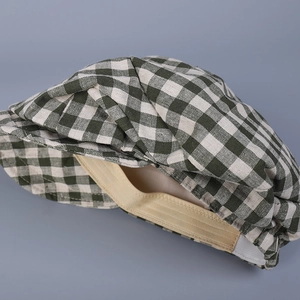 Detailed close-up of plaid linen ivy cap showing internal elastic sweatband and stitching