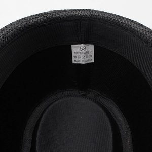Detail view of the interior sweatband and size 58 wash label on the black straw hat