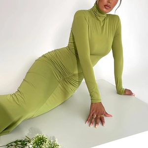 Détail d'une robe verte à manches longues, col haut et taille froncée élégante