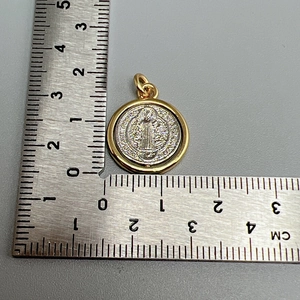 Detailed view of 2cm diameter rotatable portrait cross pendant with ruler measurement