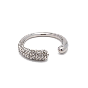 Macro shot of silver-tone open ring with polished finish and pavé-set clear crystals