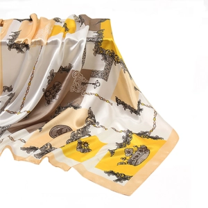 Close-up of silk square scarf featuring vintage chain, crown, and floral patterns