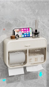 Detail of wall-mounted dual toilet paper box with textured finish and storage shelf