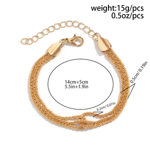 Detailed view of layered gold braided chain with lobster clasp and extension links