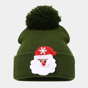 Dark green Christmas knit beanie with a fluffy pom-pom and Santa Claus patch decoration