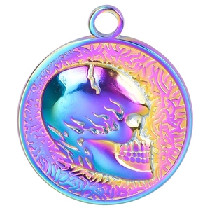 Macro shot of skull pendant with iridescent rainbow plating and intricate carved details