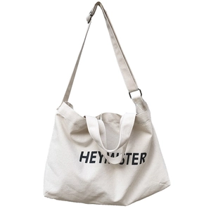 Large off-white canvas crossbody tote bag with dual handles and HEYMISTER print