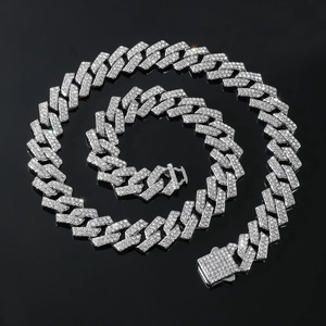 Detailed close-up of a silver-colored iced-out Cuban link necklace with crystal diamonds