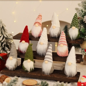 Set of 10 festive knitted Christmas gnome ornaments with colorful hats on wood shelves