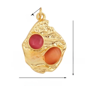 Detail view of 23mm vintage gold copper star pendant with pink and orange gemstones