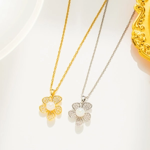 Close-up of gold and silver flower necklaces with pearls and crystals on a plate
