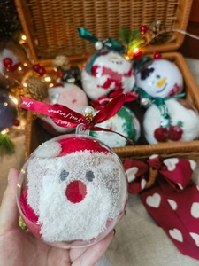 Close-up of festive Christmas coral fleece socks in a decorative transparent gift ball