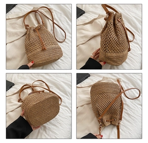 Detail view of straw bucket bag showing woven pattern, leather straps and drawstring closure