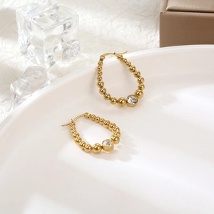 French vintage titanium steel gold beaded hoop earrings with a single clear oval zircon