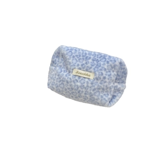 Soft blue leopard print plush makeup pouch for winter skincare and toiletries storage