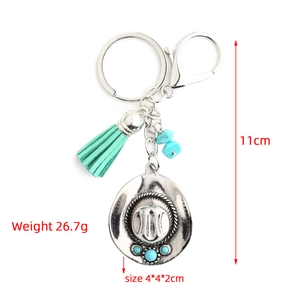 Detail view of western cowboy hat keychain with turquoise tassel and size dimensions