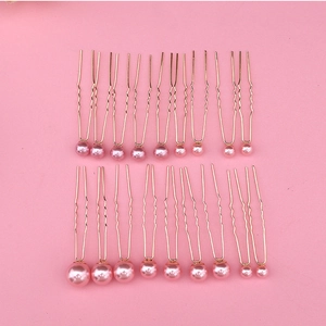 Detailed view of 18 piece pink pearl U-shaped hair pins for bridal styling and weddings