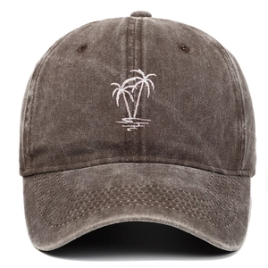 Detail of white coconut tree embroidery on a vintage washed cotton baseball cap