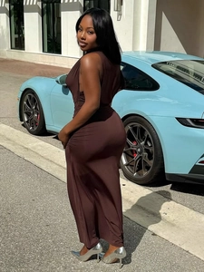 Elegant deep coffee sleeveless dress with side pleats next to a luxury car